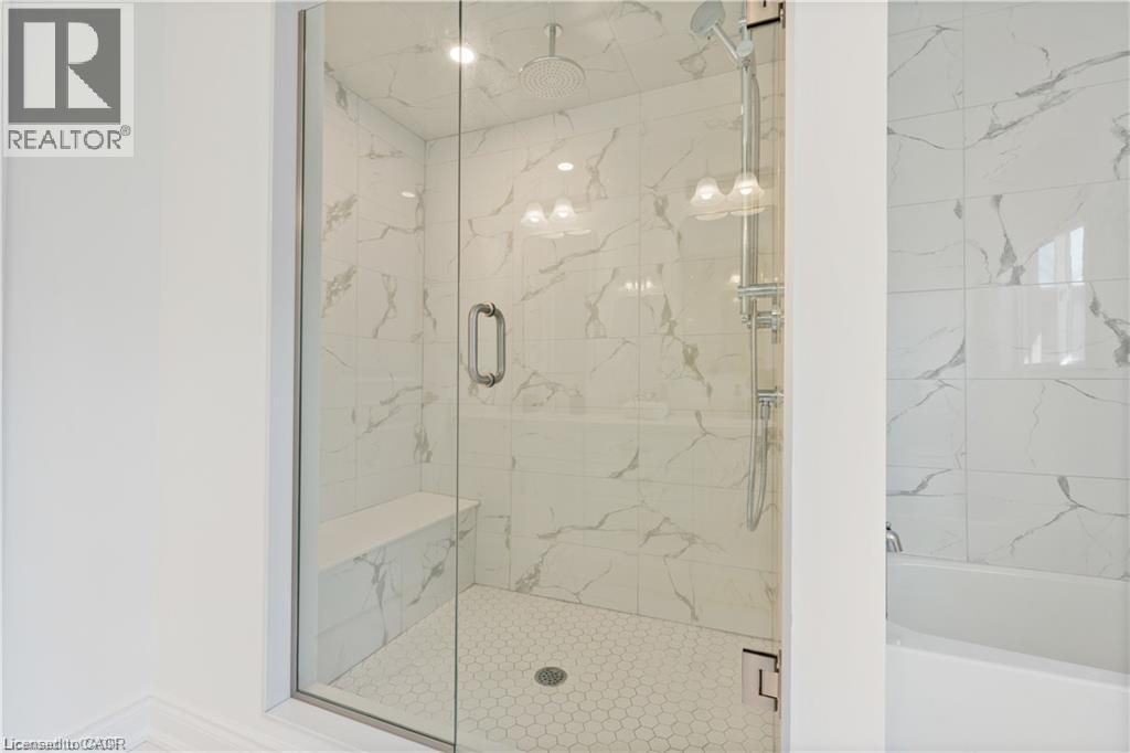 Bathroom with a marble finish shower and a garden tub