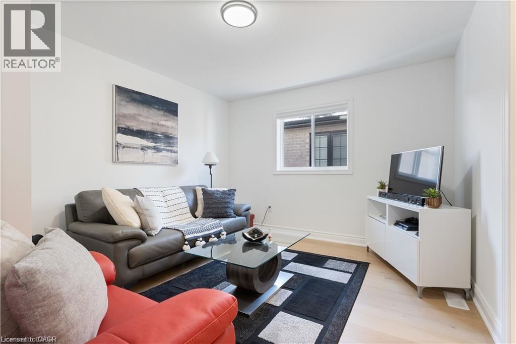 Living room with light wood-style flooring and baseboards