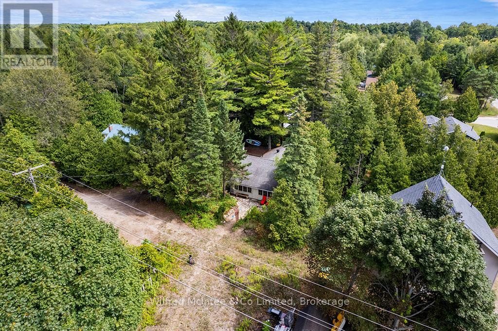 Cottage is tucked away on mature lot