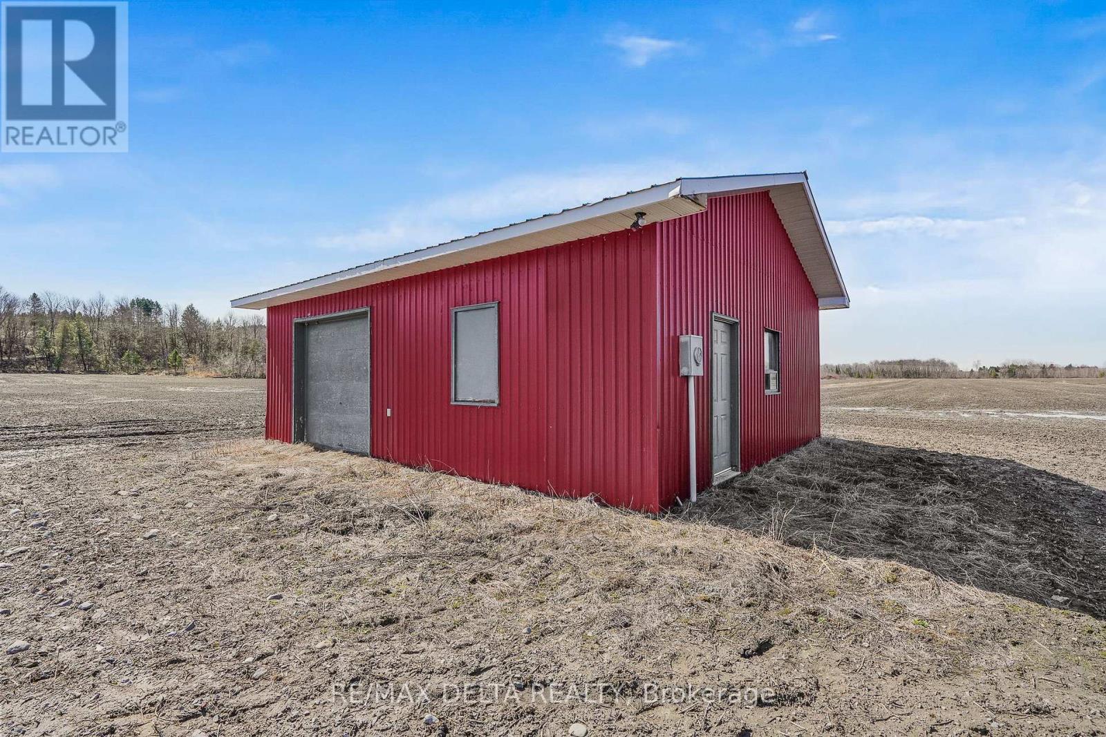 Closer view showing man door & hydro mast.