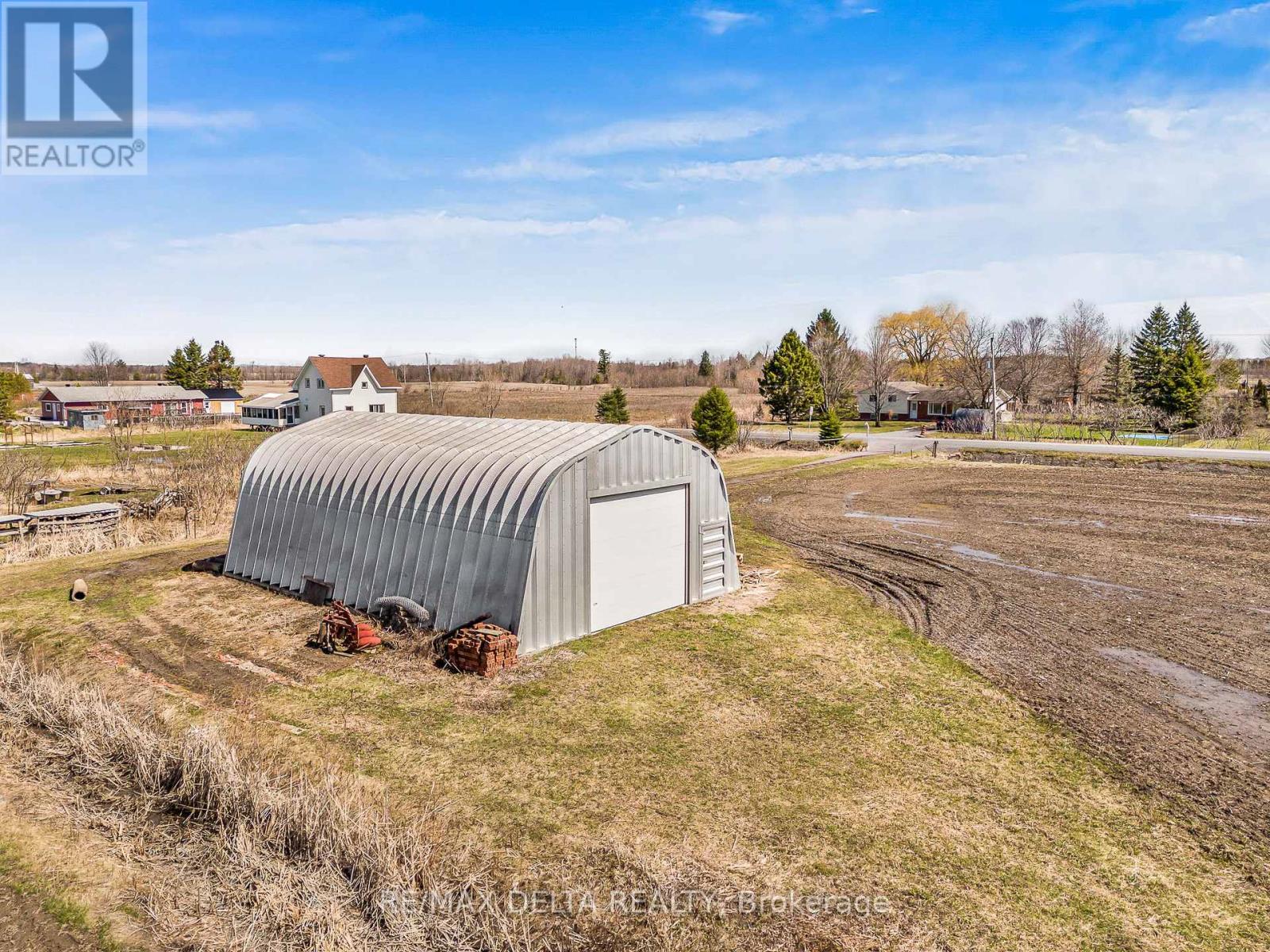 50' by 32' Metal shed on concrete slab.