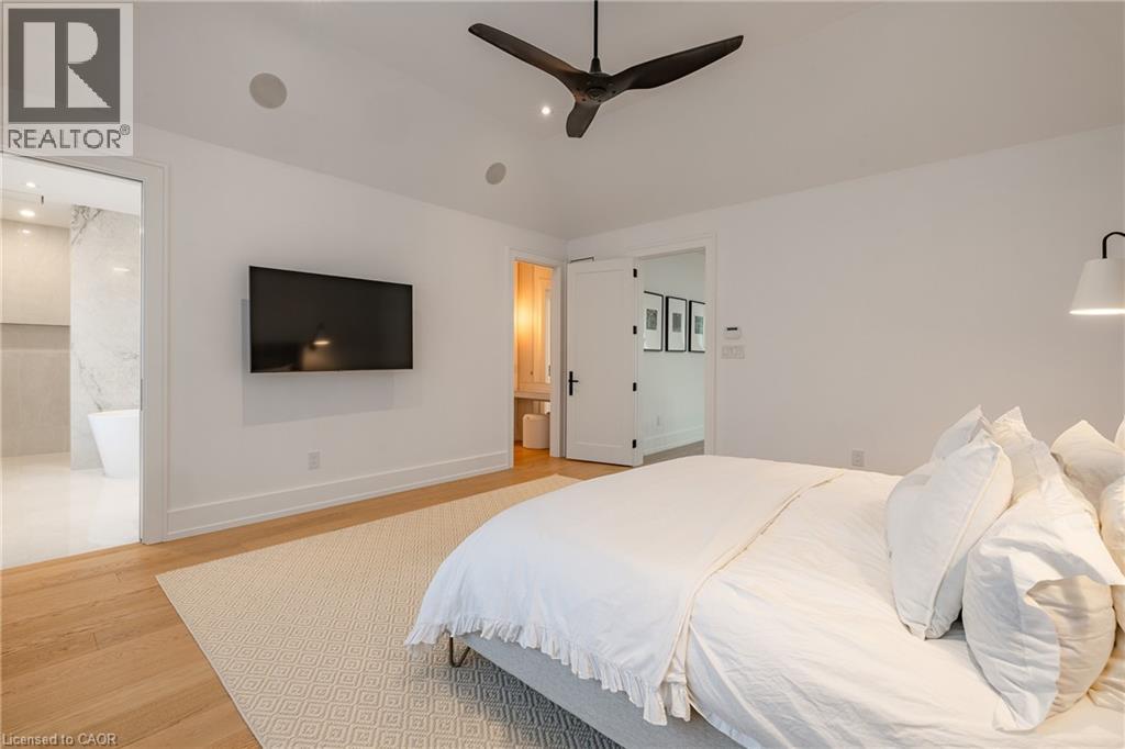 Vaulted ceiling featuring a dark-finish ceiling fan and recessed lighting