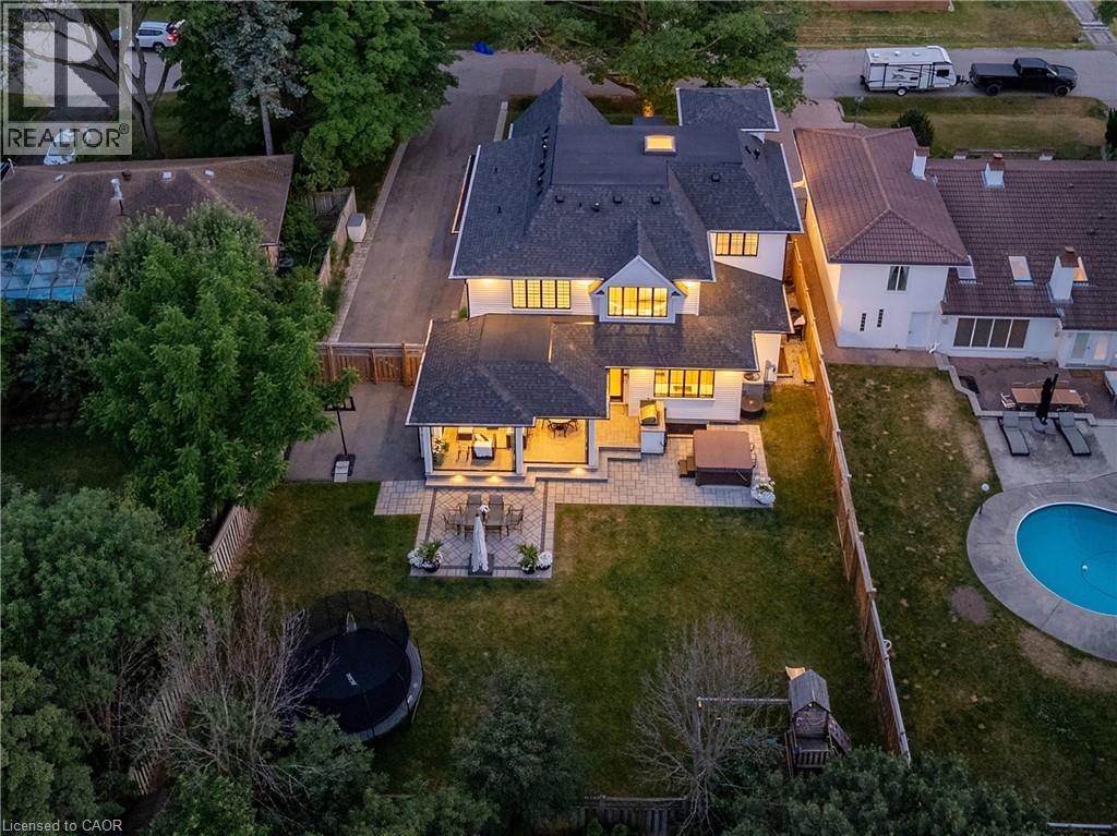 Spacious property featuring a large backyard with a manicured lawn, a covered patio area, and a stone paver patio