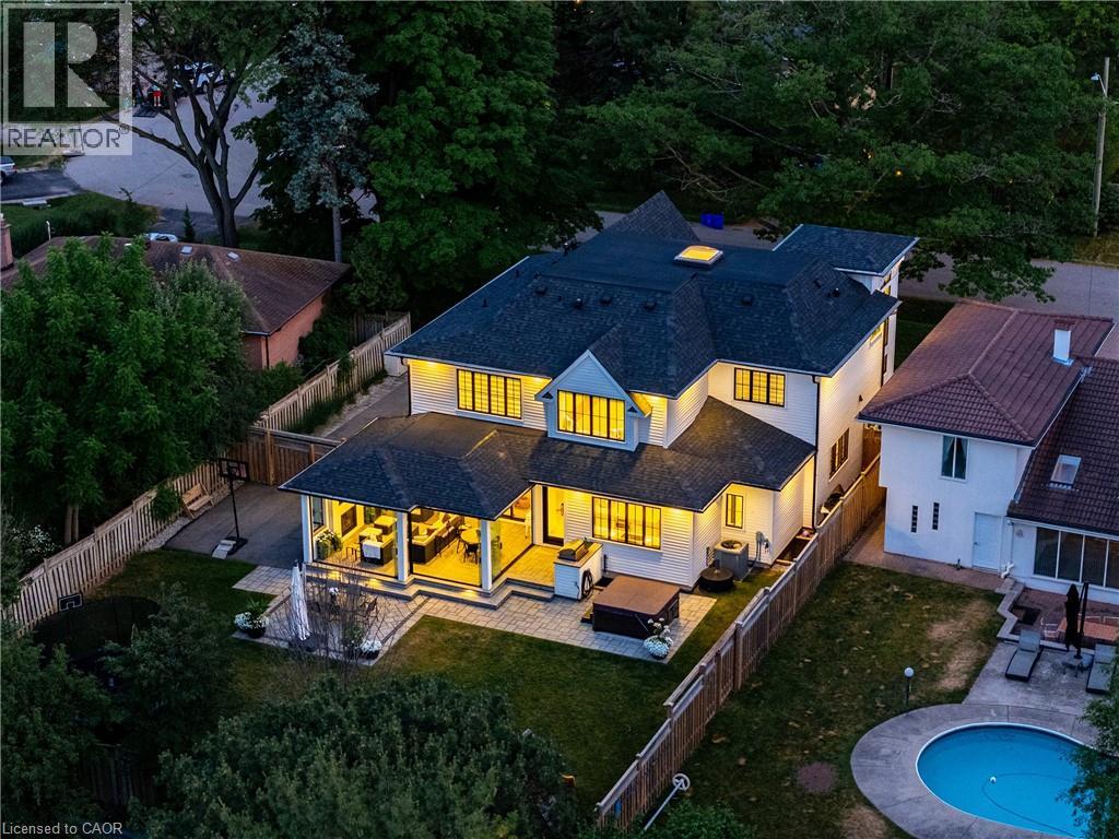 Modern residence featuring a covered patio, expansive lawn, multi-level patio space, and a spa