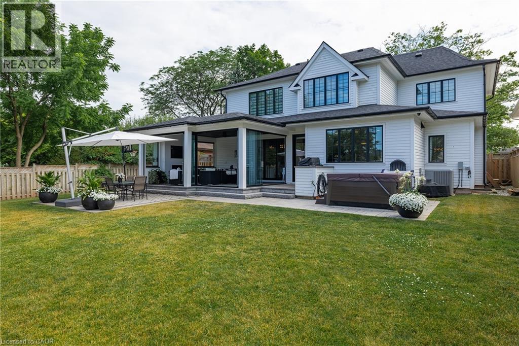 Expansive rear elevation featuring white siding and black-trimmed windows