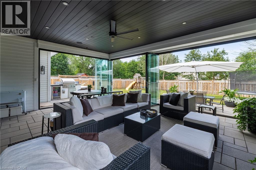 Covered patio with a dark paneled ceiling and recessed lighting