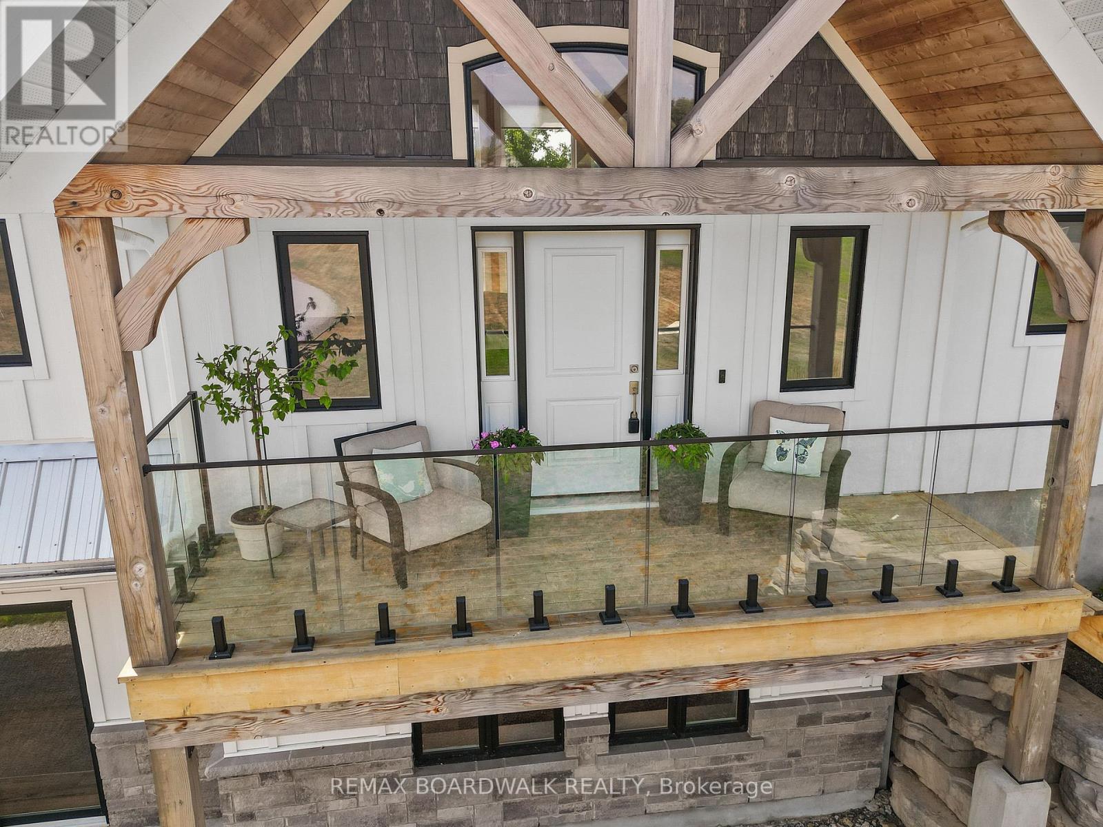 Front entry balcony with glass railings.
