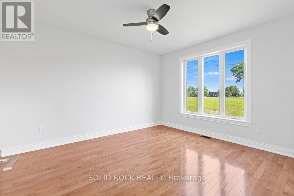 Primary bedroom also  has 9 ft ceilings & hrwd!