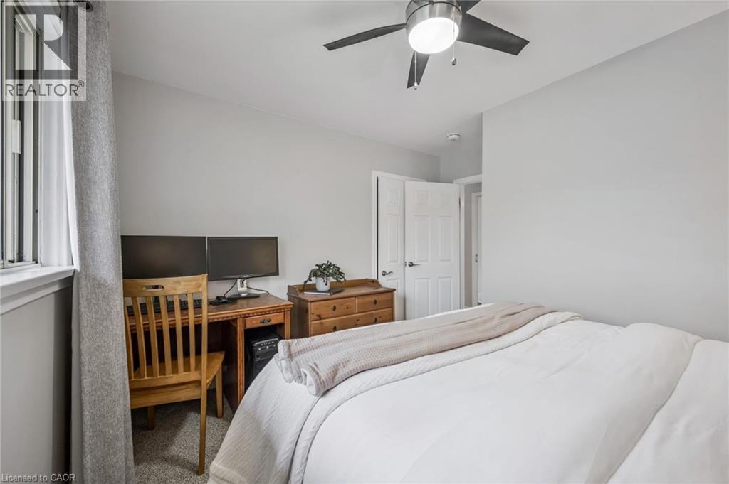 Bedroom featuring light gray walls, white trim, and a window with a curtain rod