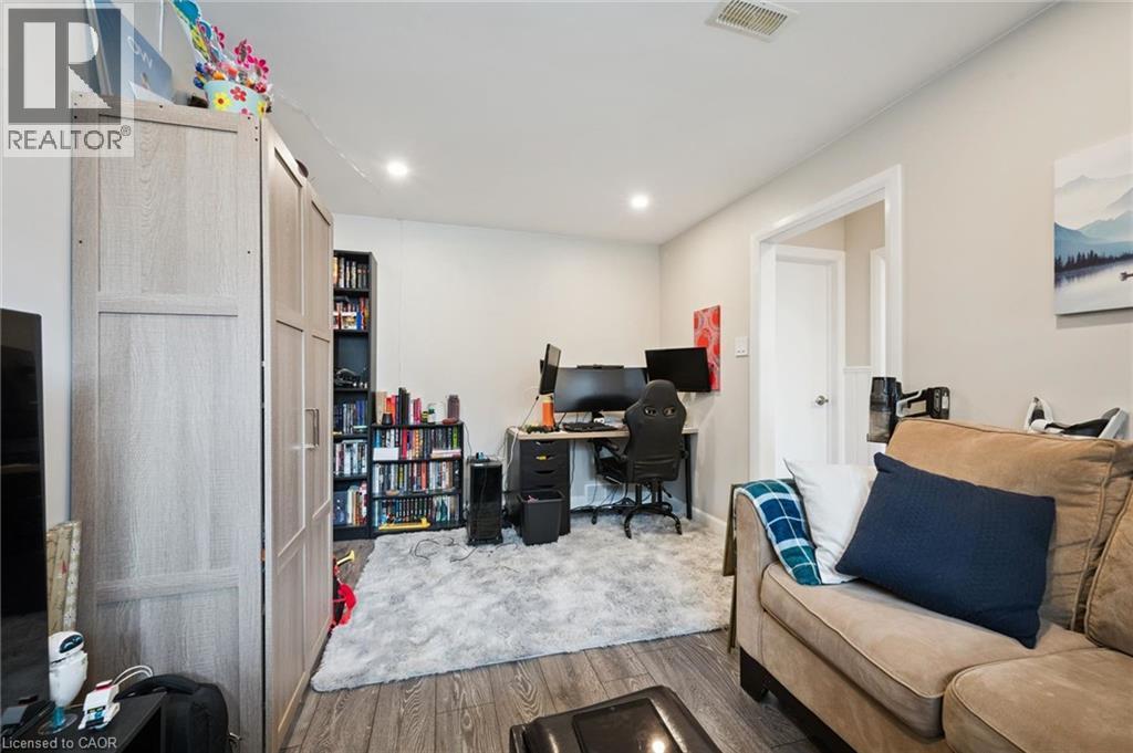 Room featuring wood-finish flooring, recessed lighting, and a neutral wall palette