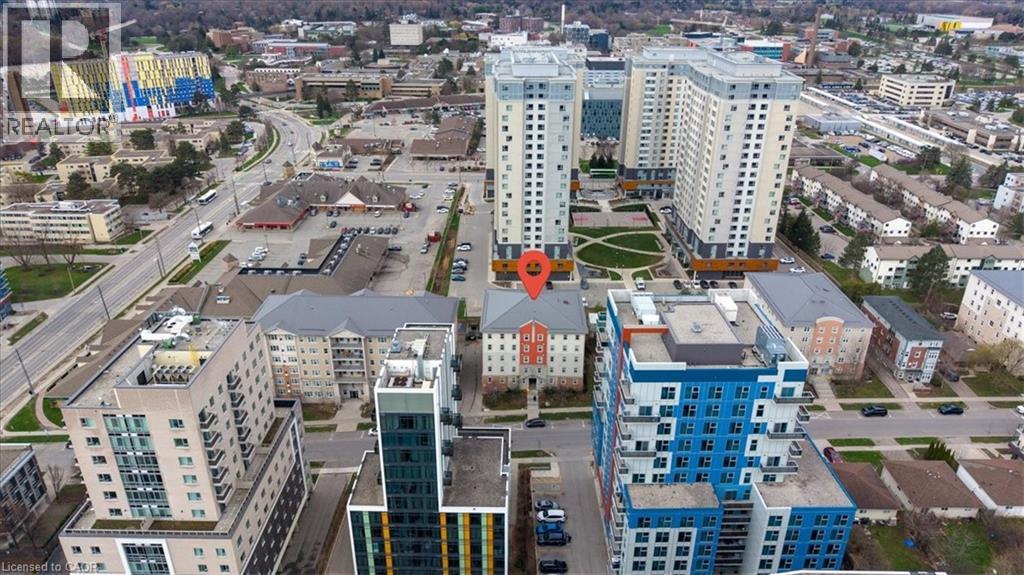 Aerial perspective showcasing a multi-story building prominently marked, surrounded by other residential and commercial structures