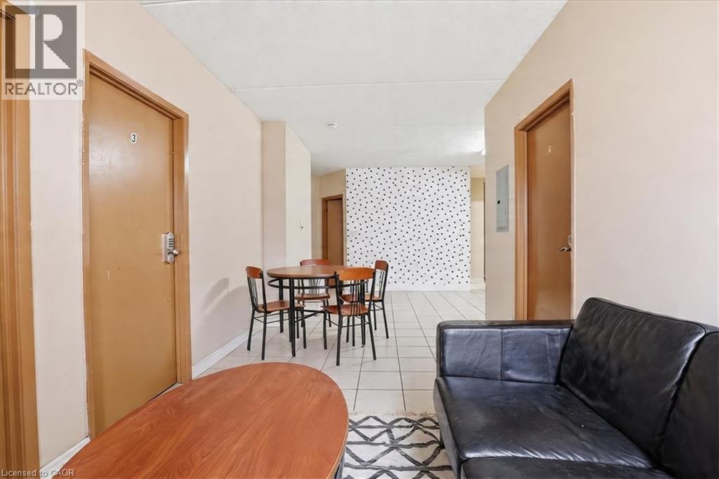 Central common area featuring light-toned walls and a white tiled floor