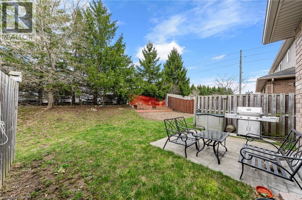 Expansive backyard with a paver patio and a large grassy area