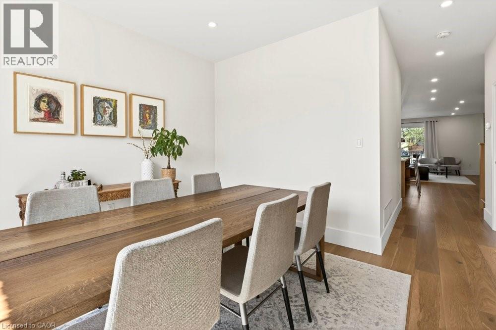Dining area with recessed lighting, light wood-finish flooring, and white baseboards