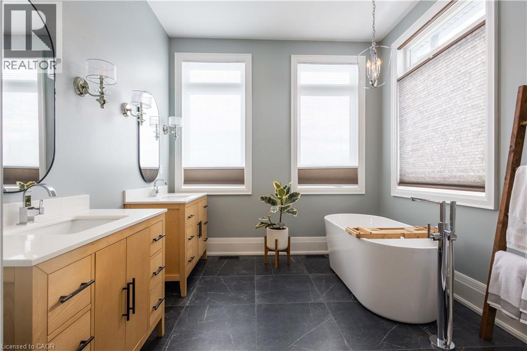 Freestanding soaking tub with floor-mounted faucet