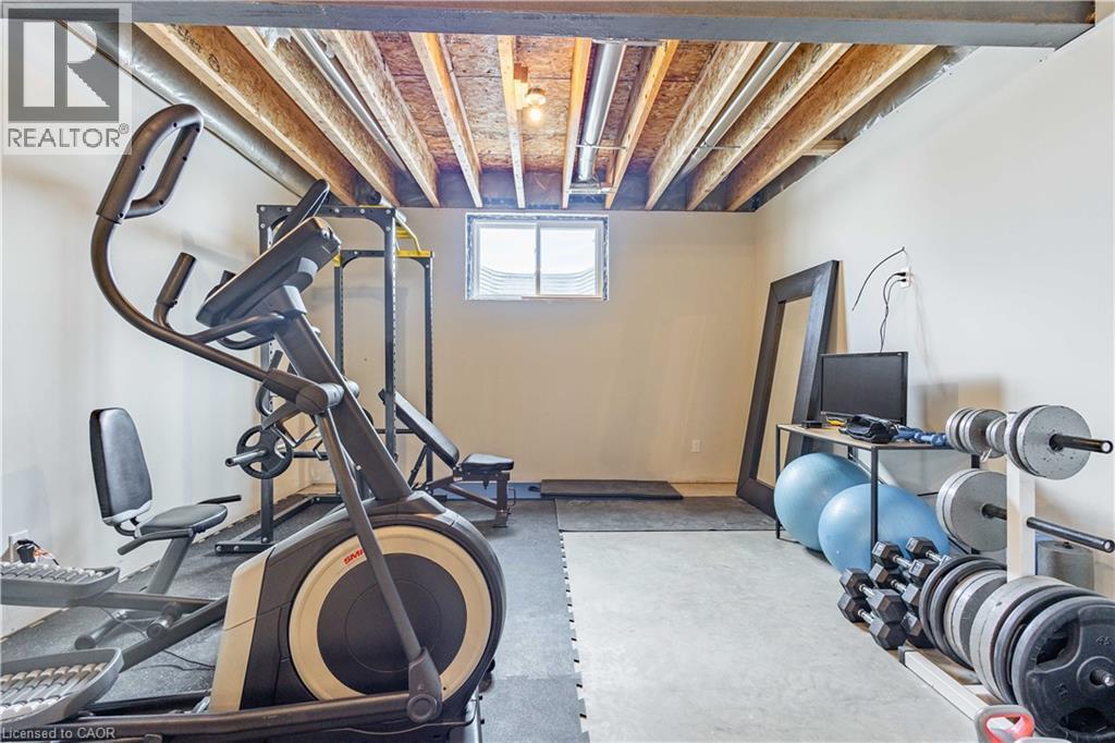 Lower level space featuring exposed joists and ductwork, with a window providing natural light