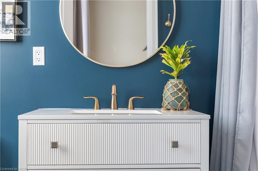 White vanity with fluted paneling, integrated sink, and bronze-finish faucet