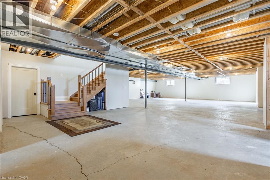 Unfinished basement with concrete flooring and exposed ceiling joists