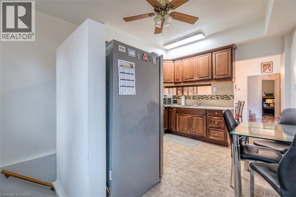 Kitchen featuring wood cabinetry, light countertops, and a tiled backsplash