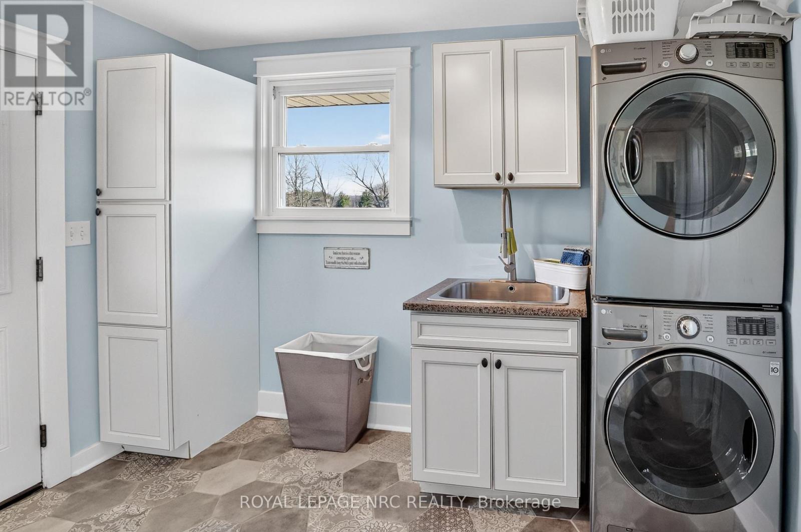 MAIN FLOOR LAUNDRY WITH BUILT IN CABINETRY