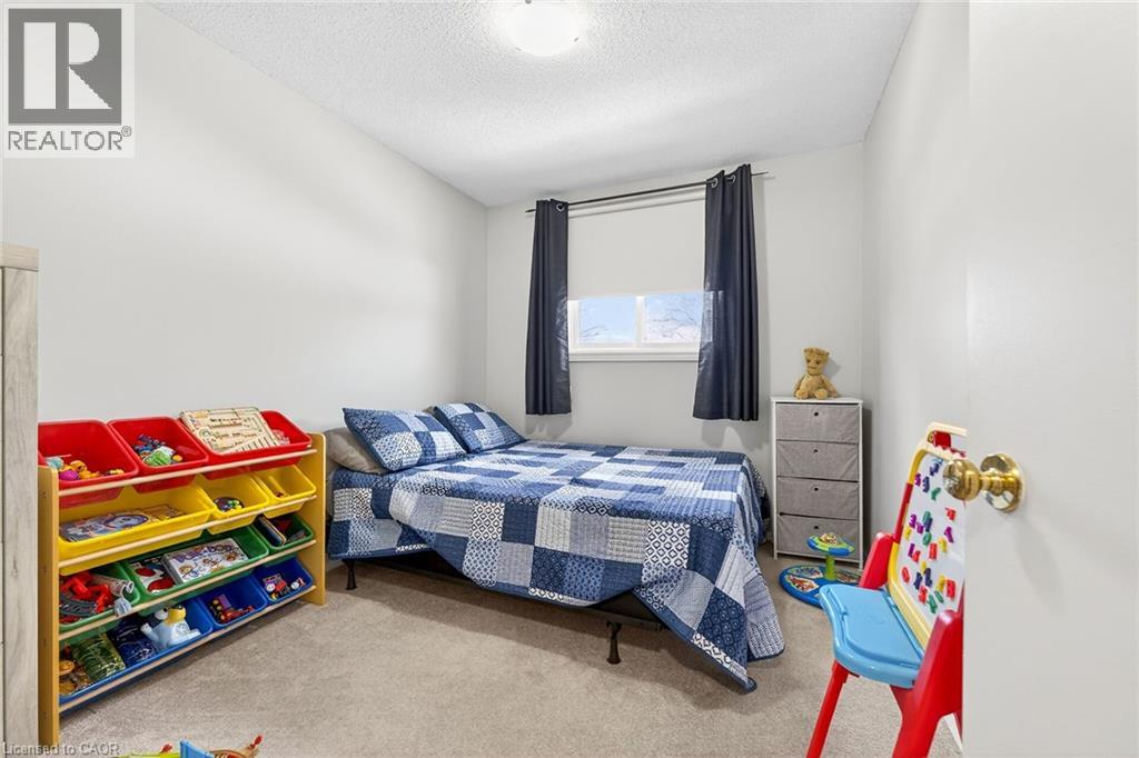 A well-lit room featuring light-colored walls and carpet flooring