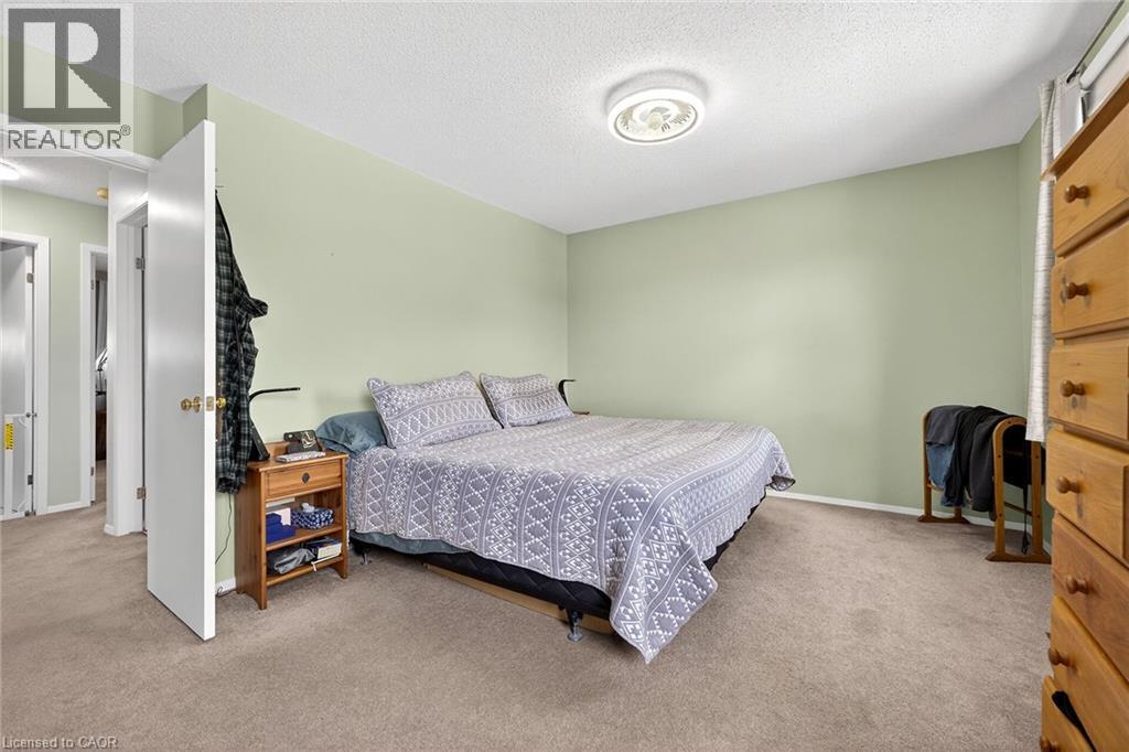 This room features light green walls and brown carpet