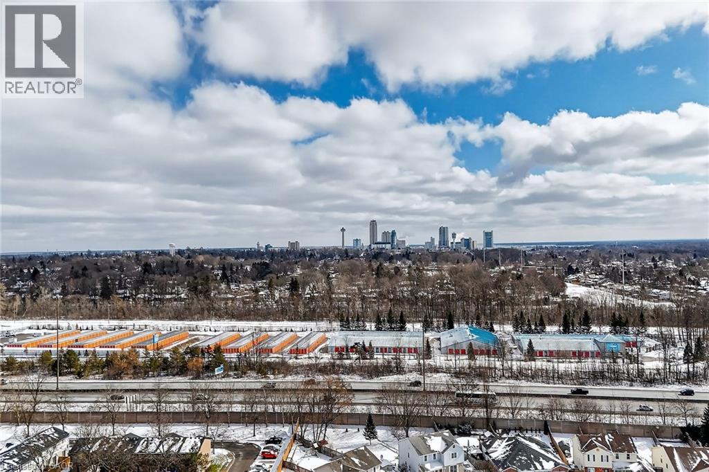 Expansive views of the surrounding neighborhood, featuring a distant city skyline, a highway, and various buildings
