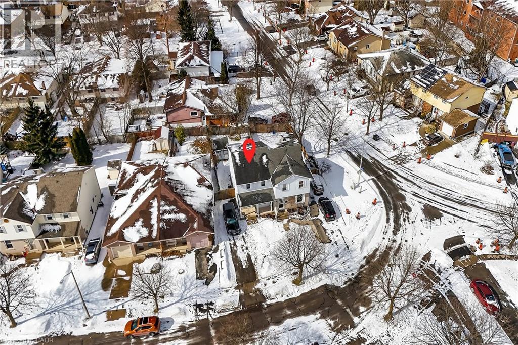 Aerial view showcasing the property situated within a residential street