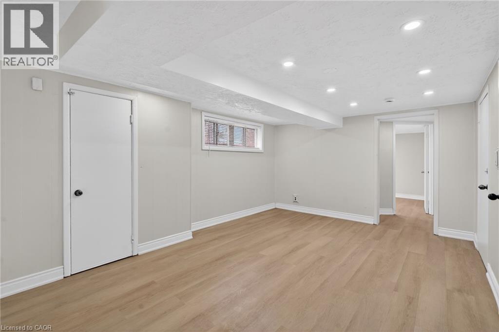 Open room featuring wood-finish flooring, recessed lighting, and a neutral color palette
