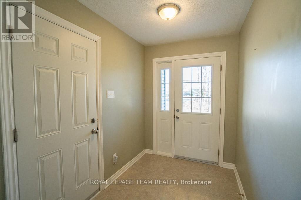Spacious foyer with garage and backyard access