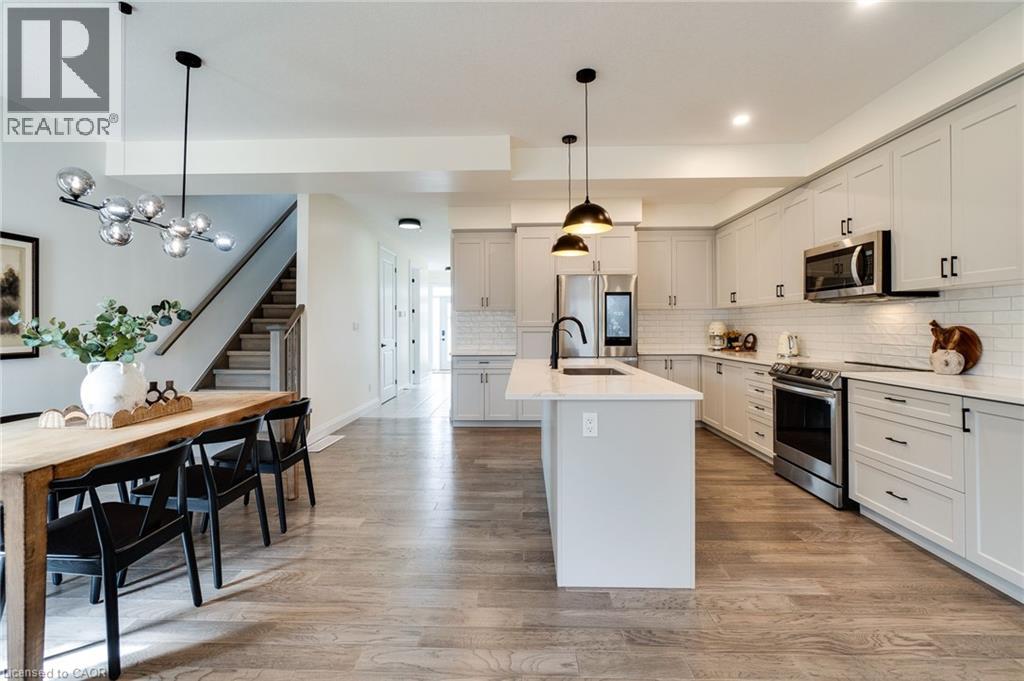 Open-concept kitchen and dining area featuring light wood-finish flooring