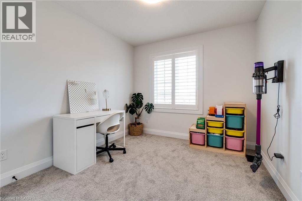 Carpeted room with a window featuring white plantation shutters, white baseboards, and a contemporary ceiling light fixture