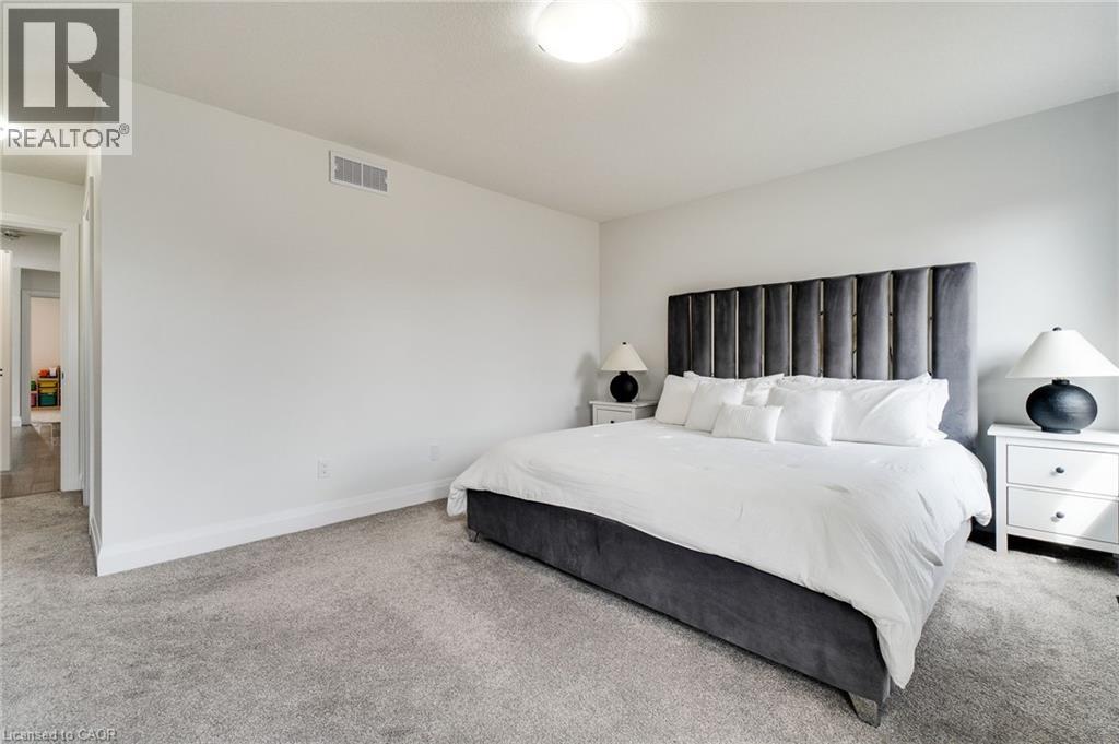 Expansive room featuring light gray carpet flooring