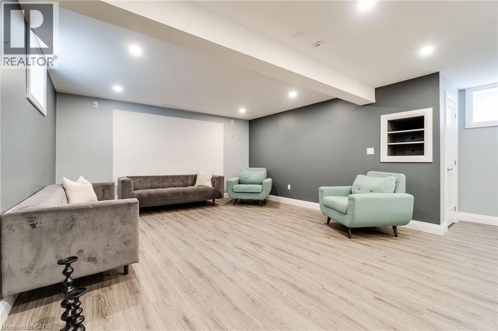 Expansive open-concept living space featuring wood-finish flooring, recessed lighting, and a built-in display nook