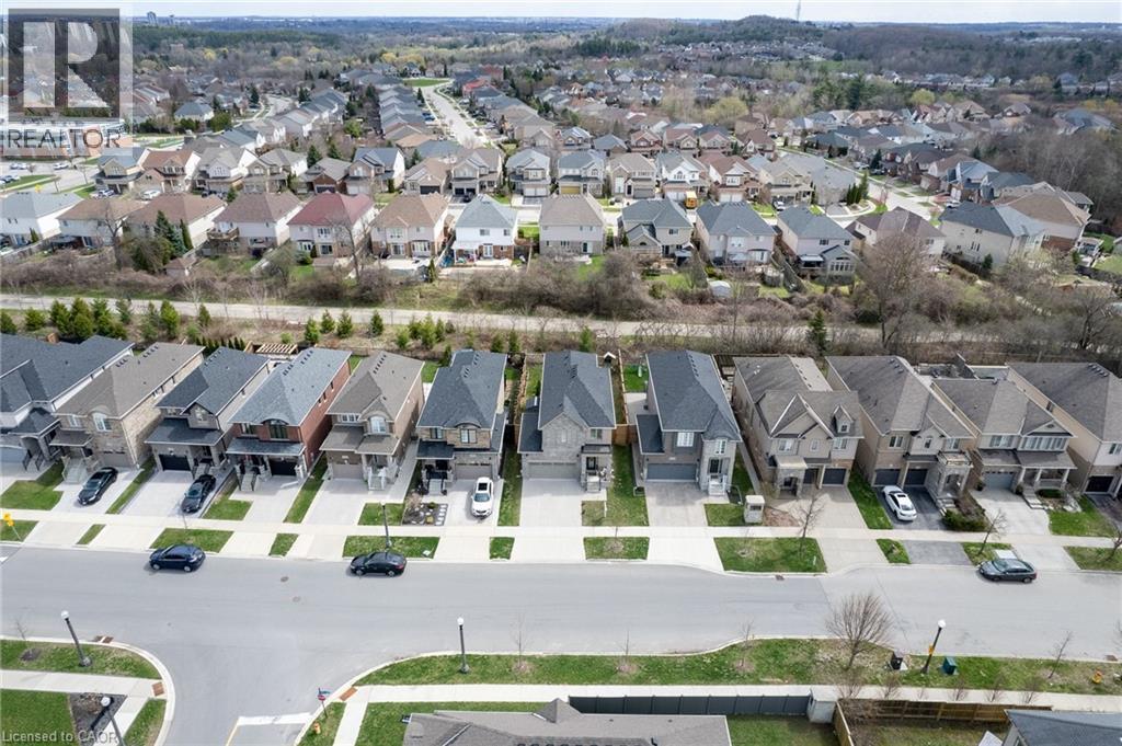 Contemporary suburban neighborhood with a street lined by detached properties featuring diverse exterior finishes, integrated garages, and paved driveways