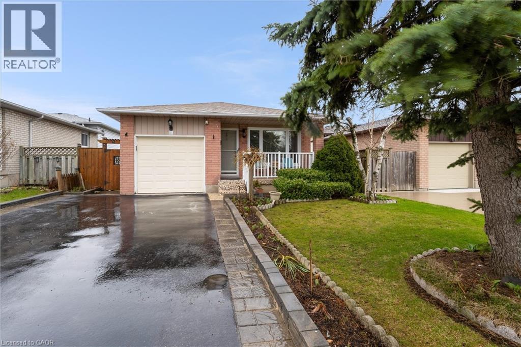 Ranch-style house with brick siding, asphalt driveway, and an attached garage