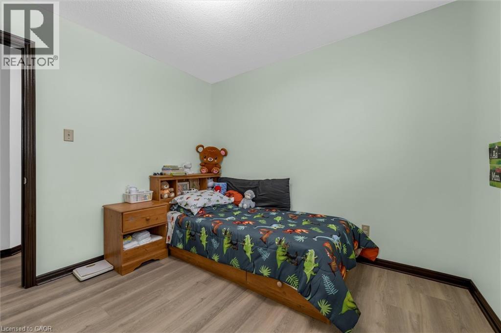 Bedroom featuring wood finished floors and a textured ceiling