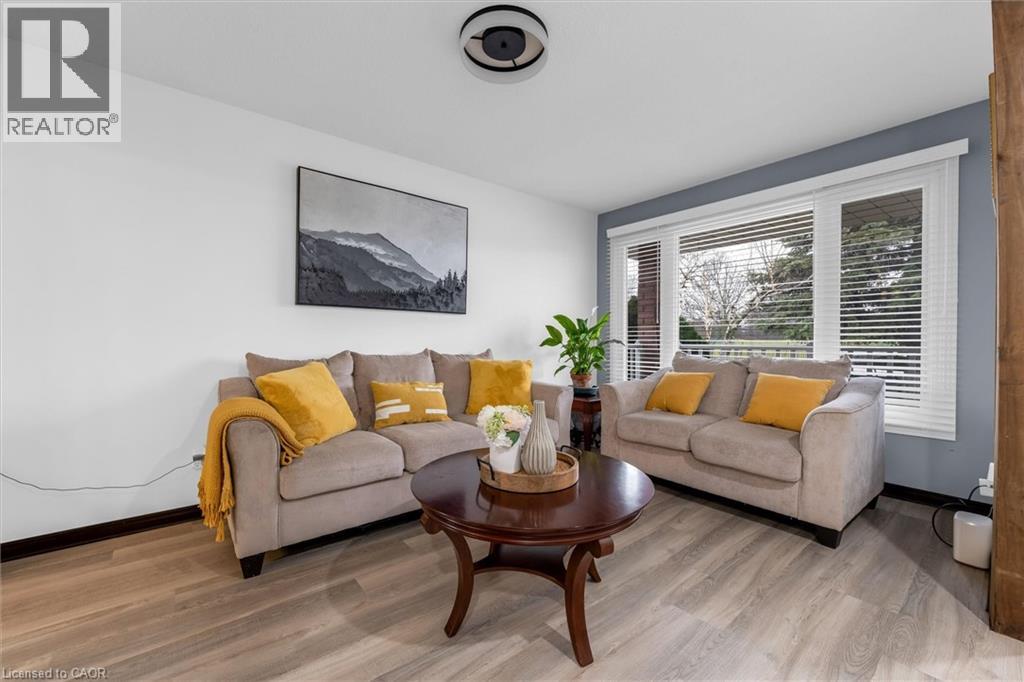 Living room featuring baseboards and light wood-type flooring