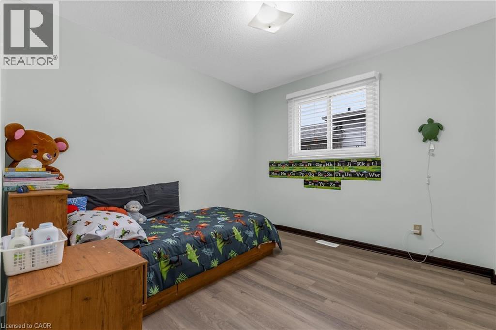 Bedroom with light wood finished floors and a textured ceiling