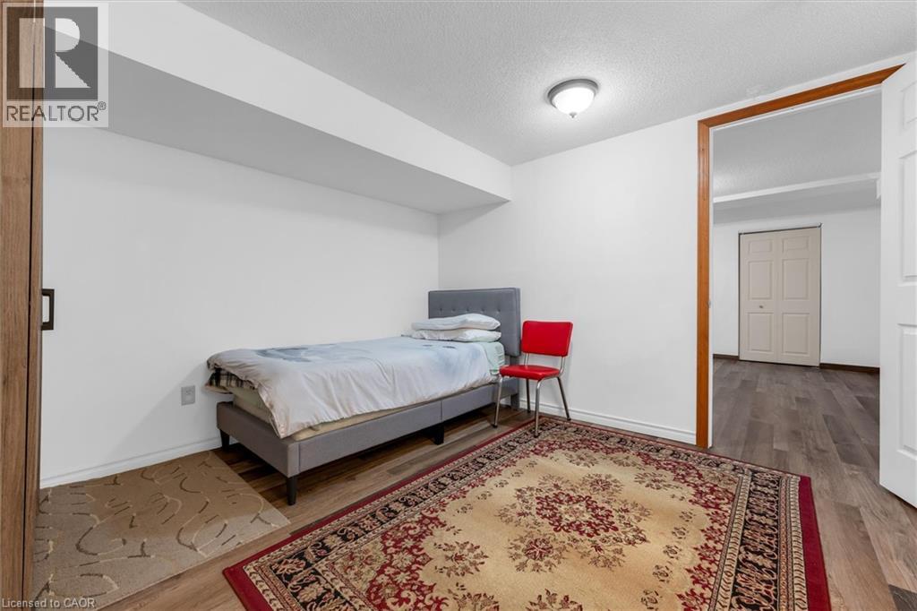 Bedroom featuring wood finished floors and a textured ceiling