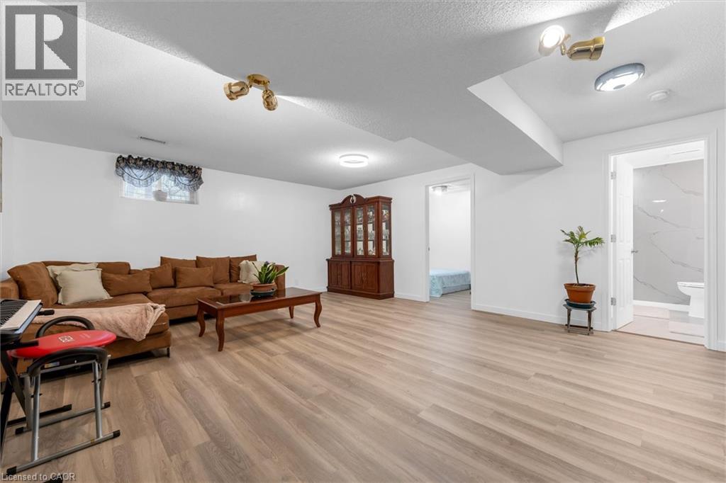 Living room with light wood-style floors and a textured ceiling