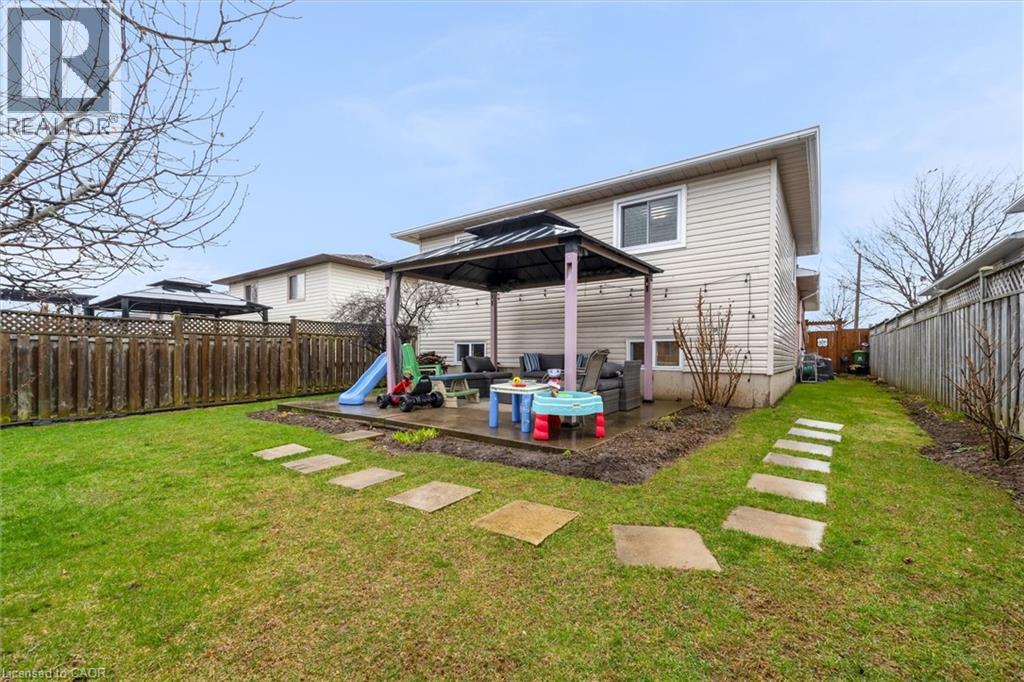 Back of property featuring a gazebo, a fenced backyard, and a patio area
