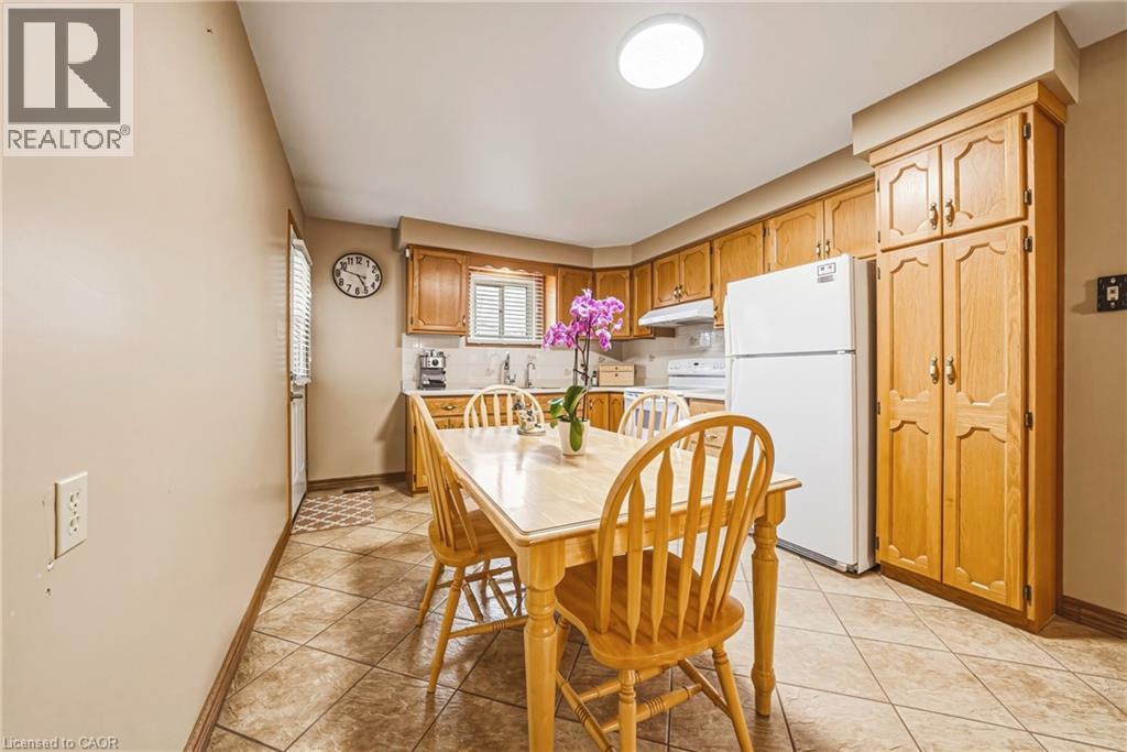 Kitchen featuring wood cabinetry, a built-in pantry, and tiled flooring