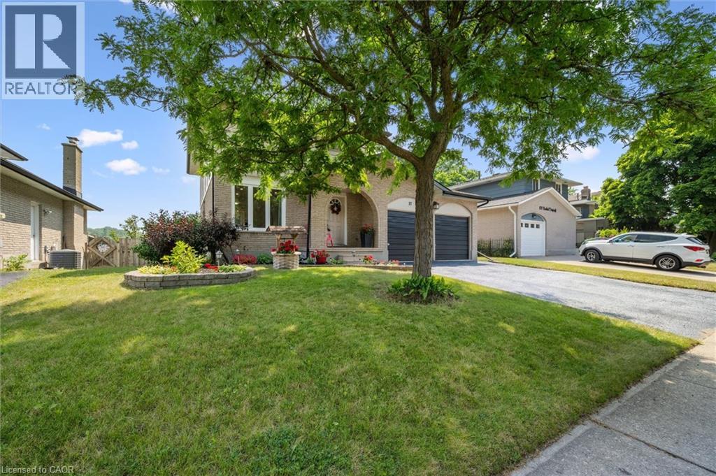 Brick exterior featuring arched garage entrances and a paved driveway