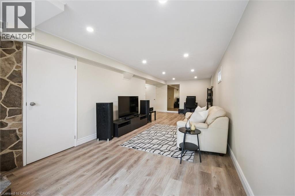 Spacious room featuring wood-finish flooring, recessed lighting, and light-toned walls