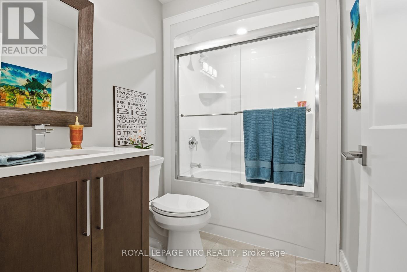 Basement 4pc bath with glass doors next to Bedroom