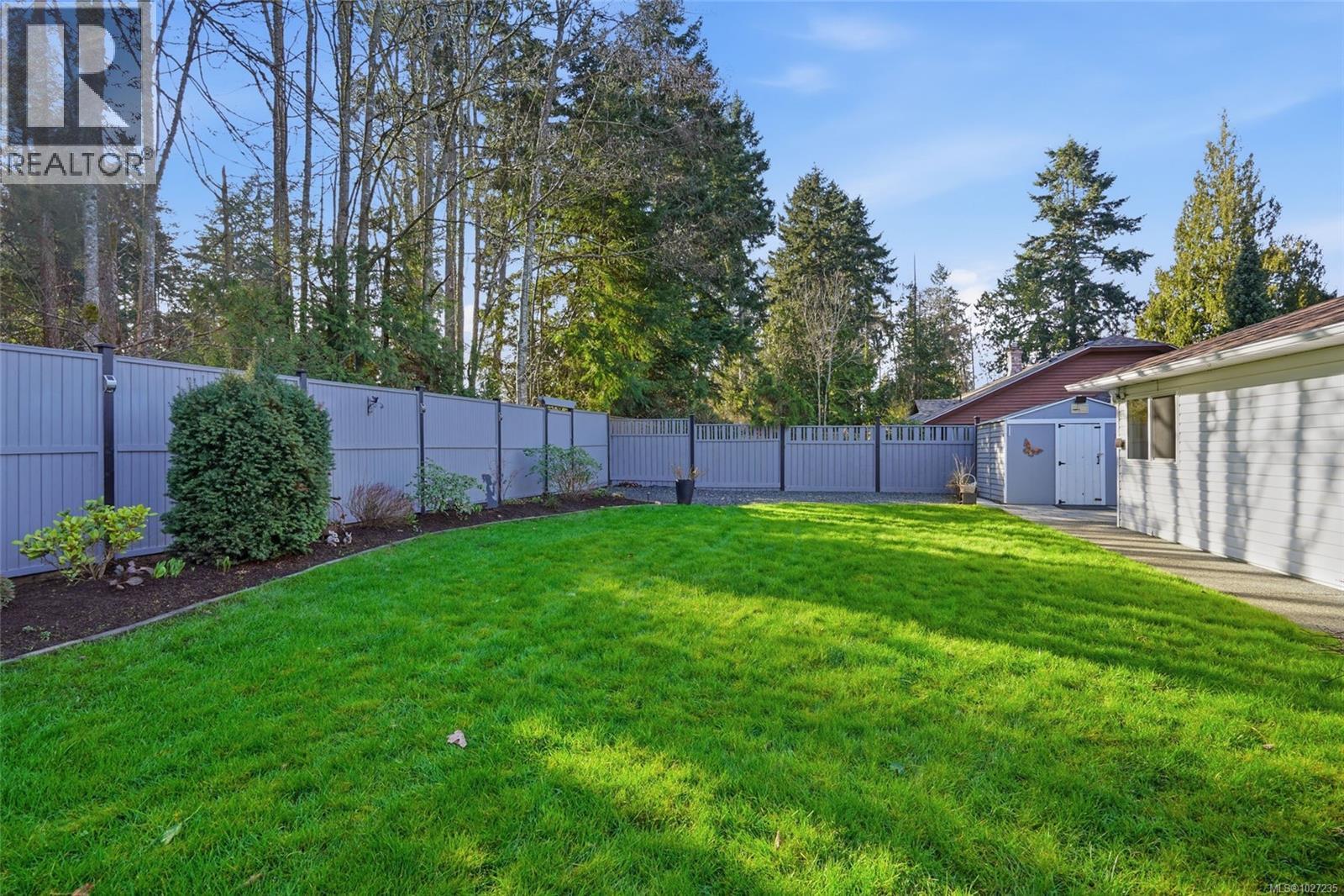 Private backyard with a beautiful forest backdrop.