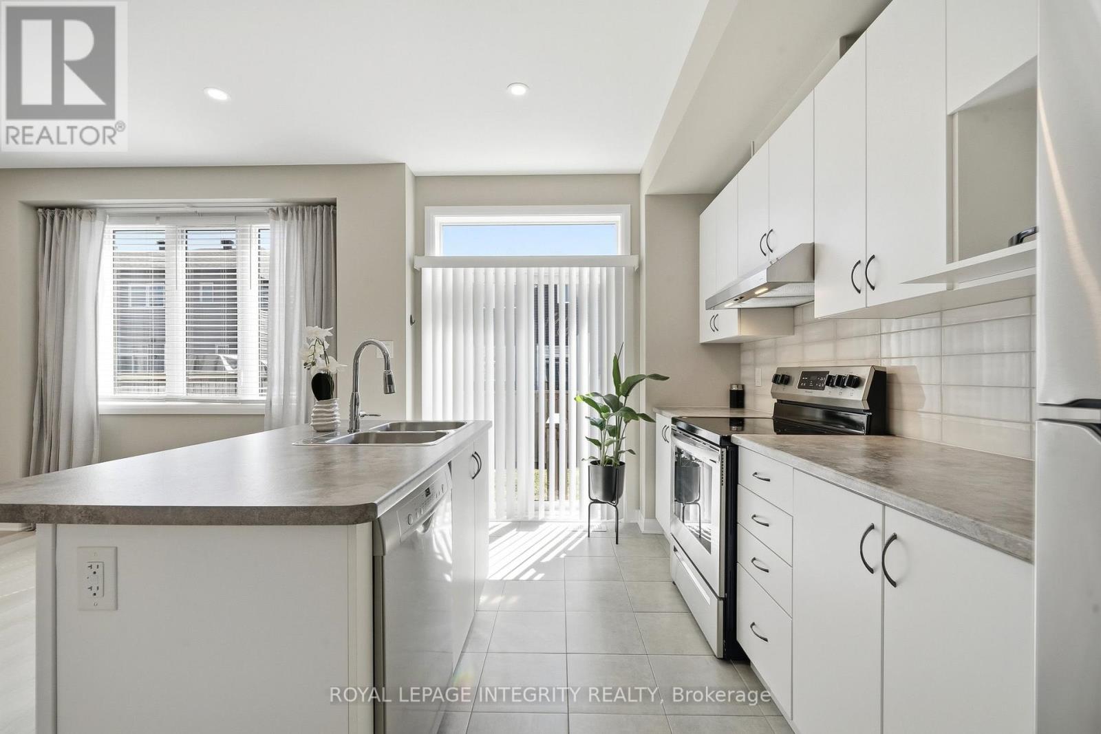 Modern sunlit kitchen with backyard access