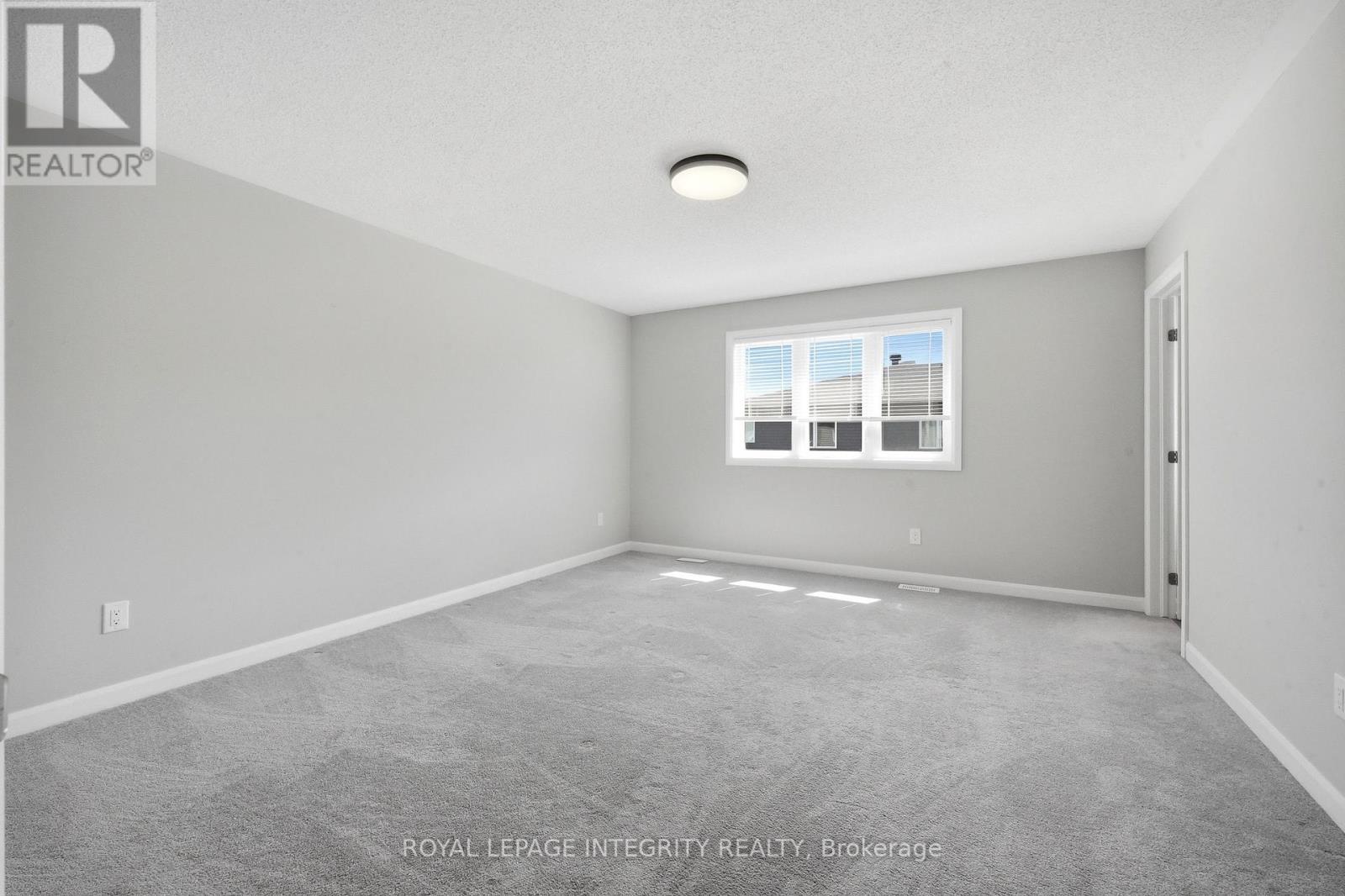 Spacious primary bedroom with sunlight & new light