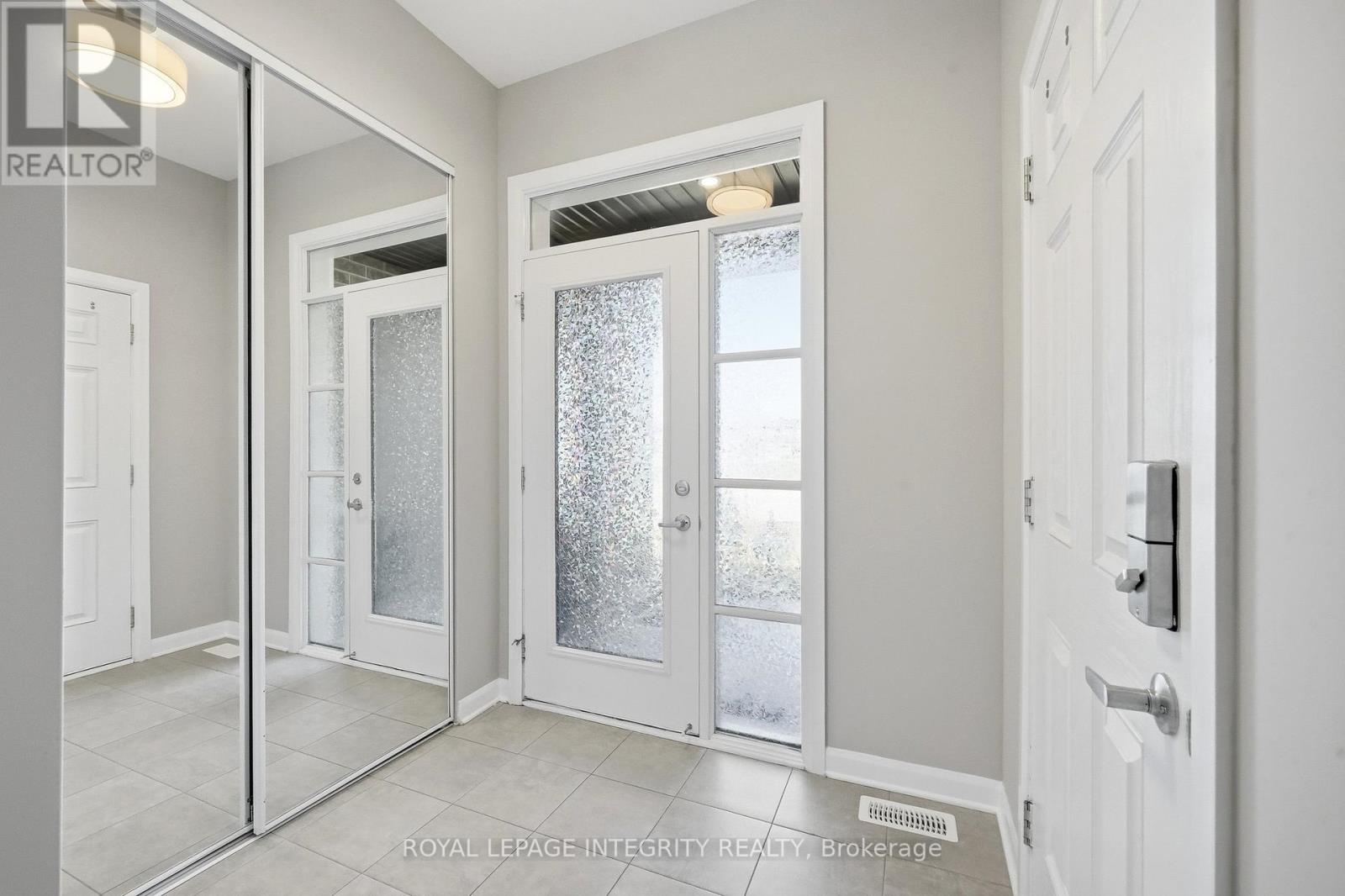 Ceramic Foyer With Mirrored Closet & Garage Access